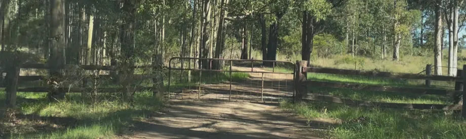 The North Gate at the dead end, with a metal farm gate across the dirt road